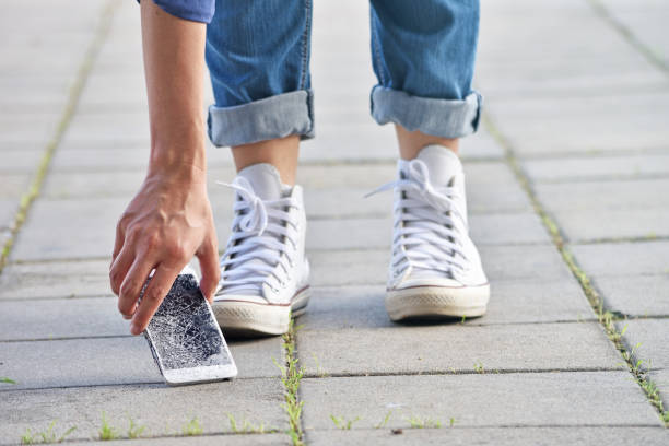 istock Person Picking Broken Smart Phone 1157756619