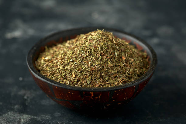istock Fresh and dried mint in bowl. on black rustic table 1157756863