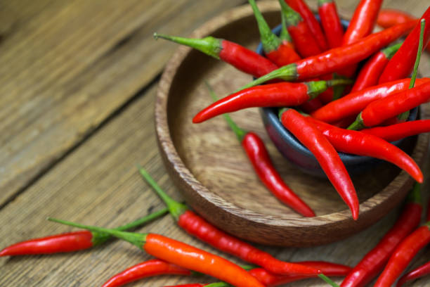 istock Fresh red chili peppers on old wooden table 1157758030