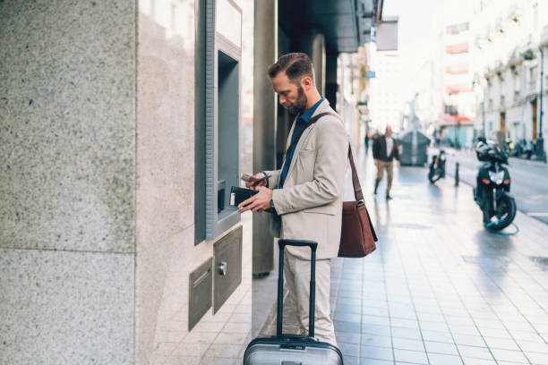 istock Businessman withdrawing money 1157761873