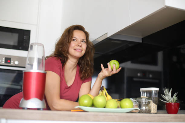 istock Pregnant woman preparing a fruit juice 1157762515