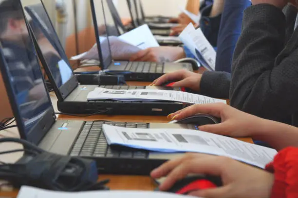 Photo of Students in a computer class. Students in front of computers in a computer class