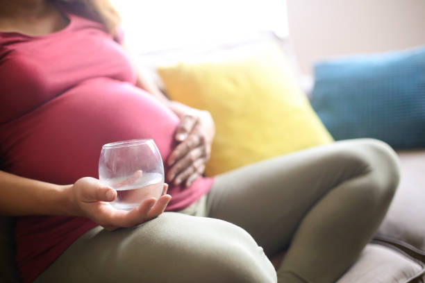 istock Pregnant woman drinking cold water 1157763376