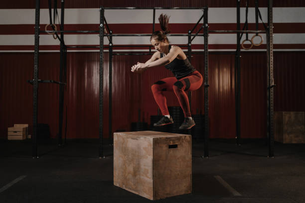 istock Young woman doing box jumping at the gym. 1157765124