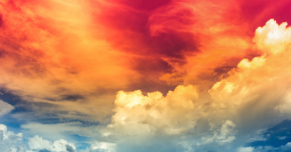 hot red color light in dim blue sky with soft clouds