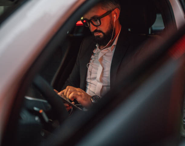 istock Businessman sits in his vehicle 1157771372