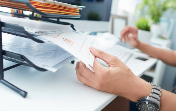 istock Close-up of a man's hand pulling files from office shelves. 1157775888