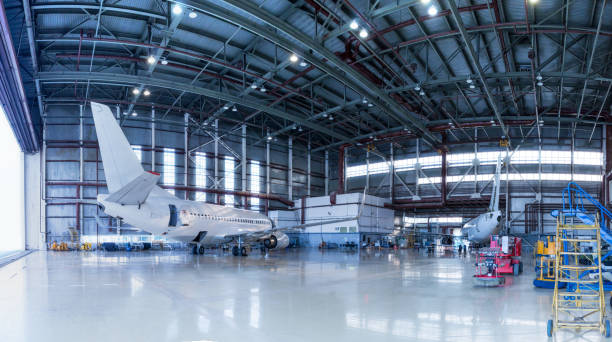 istock Passenger aircrafts under maintenance. Checking mechanical systems for flight operations. Panorama of airplanes in the hangar 1157776570