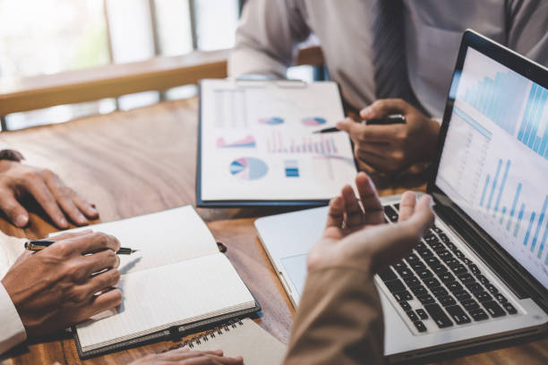 istock Business team working with new startup project plan and discussion information for financial strategy with laptop and digital tablet in a modern business lounge 1157779435