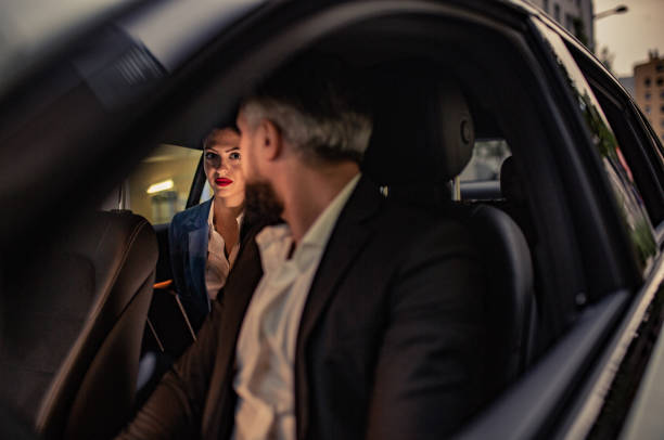 istock Businesswoman is driven by your chauffeur 1157779948