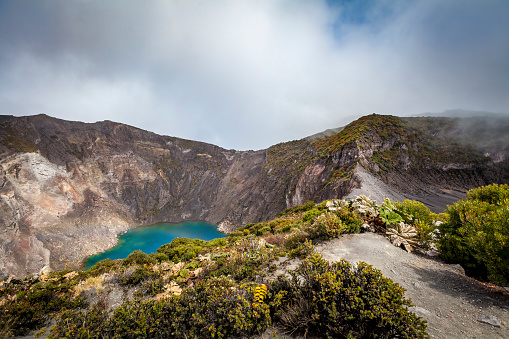 blue chemical sulphur water at the volcano crater lake of irazu volcano in costa rica at 3200 metres above sea level.