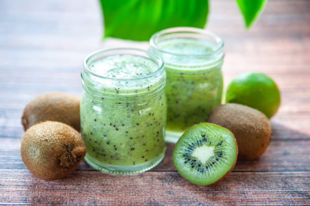 istock Kiwi smoothies in glass cups on a wooden table 1157784646