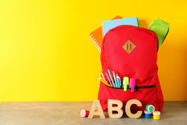 istock School supplies on grey table against color background, space for text 1157785949