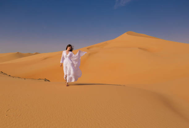 istock UAE. Woman in desert 1157786112