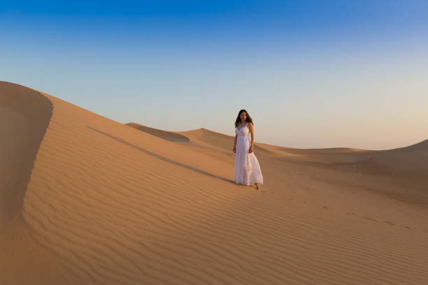 istock UAE. Woman in desert 1157786203