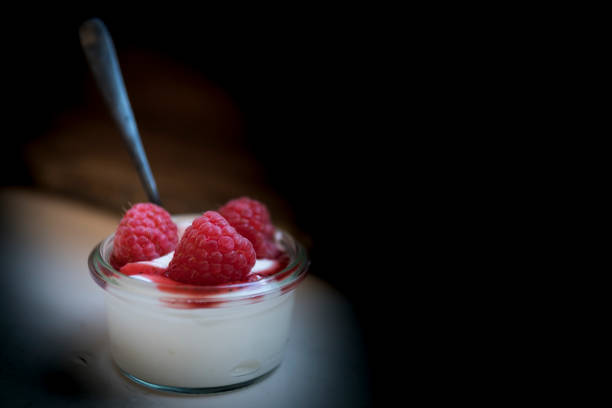 istock close up. glass bowl with yogurt and raspberry 1157786714