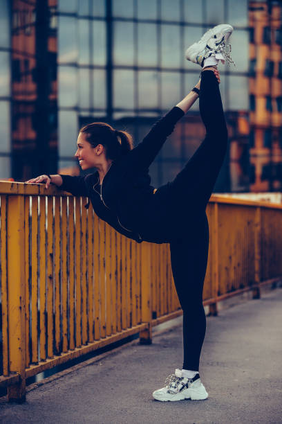 istock Girl warming up on river bridge, preparing for evening workout 1157788744