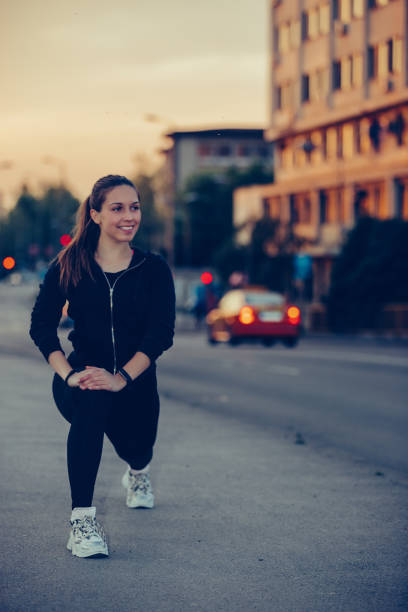 istock Girl stretching her legs on river bridge, preparing for evening workout 1157788745