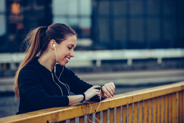 istock Sporty girl checking progress on smart watch on the bridge 1157788752