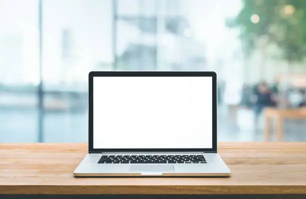 Modern computer,laptop with blank screen on counter bar(retail store shop)and window view backgrounds