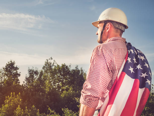 istock Young engineer, white hardhat and American Flag 1157790085