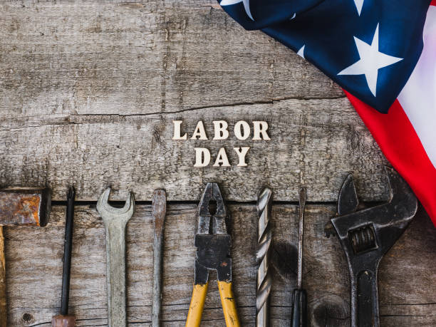 istock LABOR DAY. Hand tools and wooden letters 1157790344