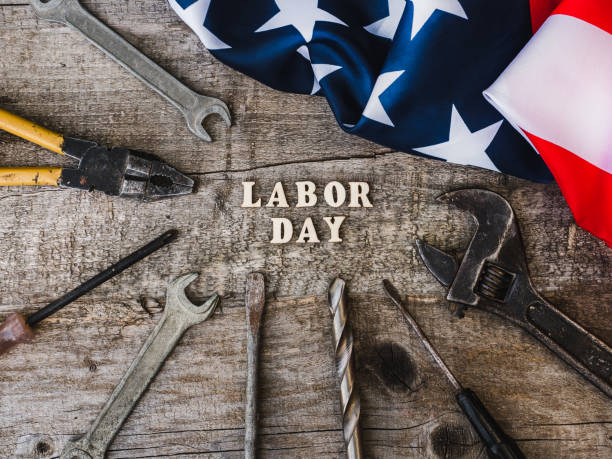 istock LABOR DAY. Hand tools and wooden letters 1157790387