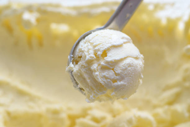 istock Ice cream scooping out of container by metal spoon close up 1157792119