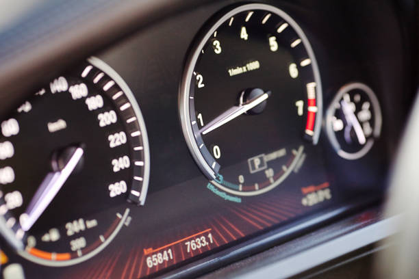 istock Electronic dashboard of modern luxury car view from aside. Speedometer blurred with selective focus on the arrow and tachometer scale 1157793162