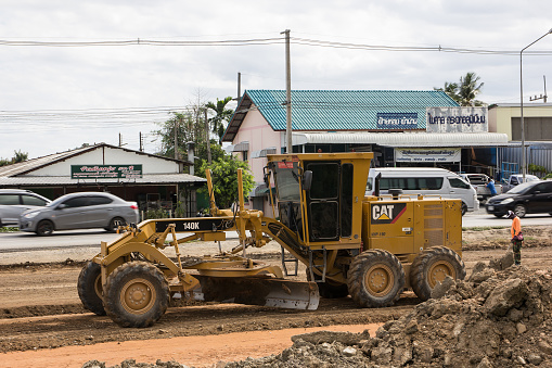 Chiangmai, Thailand - June 21 2019: Cat 140k motor grader on Construction site. Photo of new road no.121 outside ring road of chiangmai city.