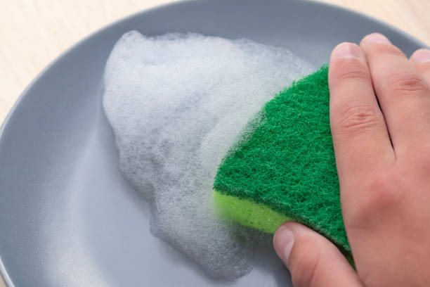 istock Kitchen green sponge with foam detergent on a gray plate 1157798445