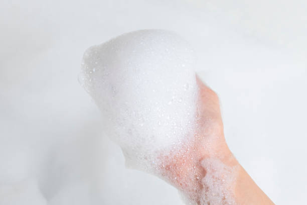 istock Hand with foam while bathing and cleaning the bathroom 1157798807