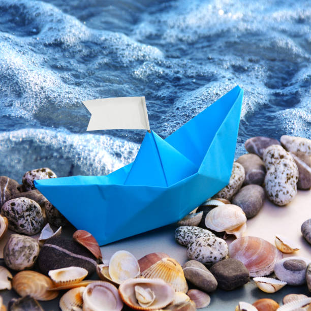 istock Paper Boat at Sea. 1157799047