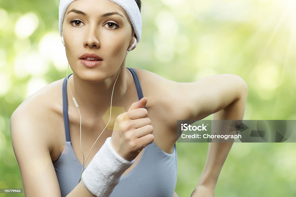 A young woman running while listening to music girl in sport on the nature Active Lifestyle Stock Photo