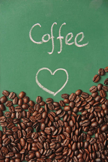 istock Top view of scattered Coffee bean on wooden board 1157799828