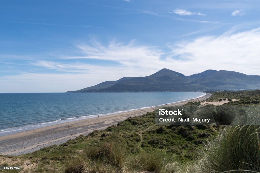 Coastal dunes, beach shoreline and mountains Coastal dunes, beach shoreline, receding tide and the outline of the Mountains of Mourne at Newcastle, County Down, Northern Ireland. Newcastle - County Down Stock Photo