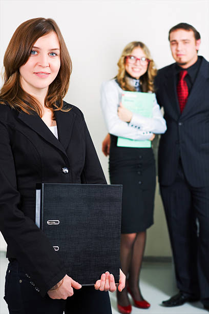 istock Young businesswoman with a folder 115780300