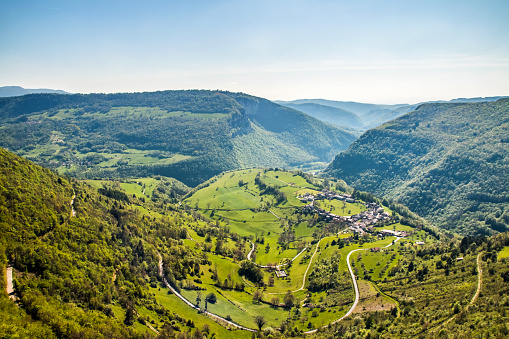 Beautiful nature landscape high angle view of small old French village of Oncieu in circle shape, in valley of Bugey mountains in Ain department