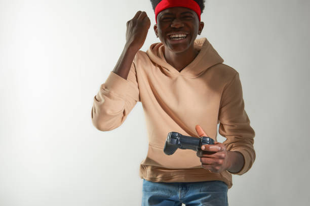 Happy Afro American guy playing video game