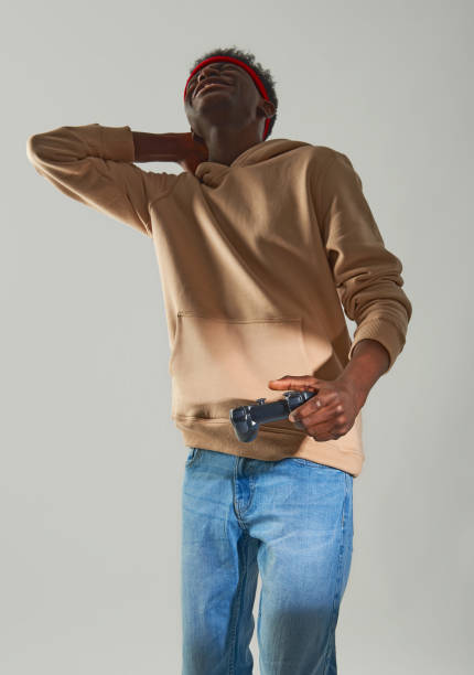istock Upset Afro American guy holding game console 1157803310