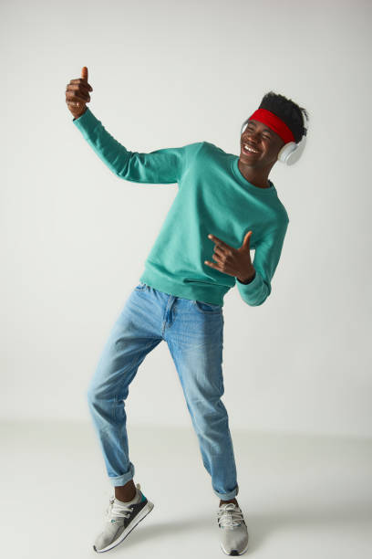 istock Happy young guy with red bandage is dancing 1157803315