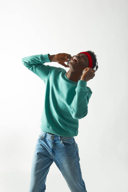 istock Smiling young man with red bandage dancing 1157803317