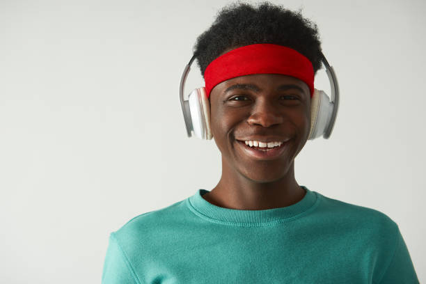 istock Smiling Afro American guy is using headphones 1157803331