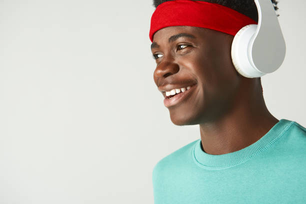 istock Happy Afro American guy standing with headphones 1157803337