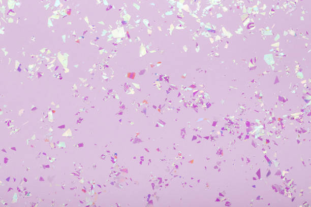 Red glowing mica sparkles on violet pastel trendy abstract background.
