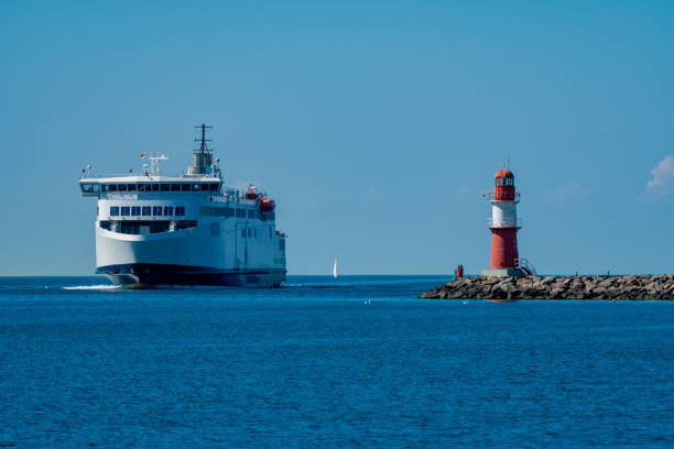 Aproaching ferry and red beacon on the pier in Warnemuende/Rostock