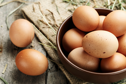 Brown eggs in a plate. Rural scene