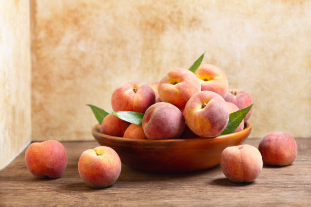 istock fresh peaches with leaves in a bowl 1157804706