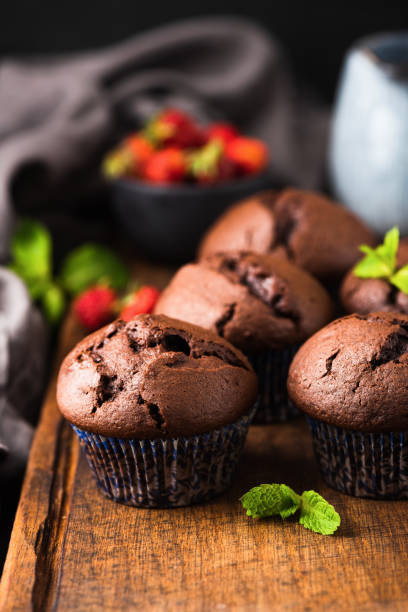 istock Dark chocolate muffins on wooden board 1157804986