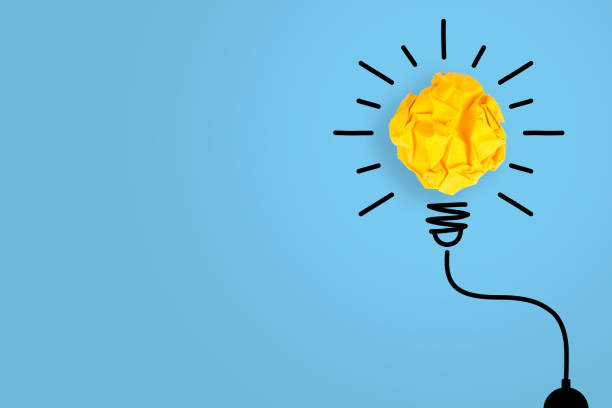 istock Idea Solution Concepts Light Bulb Crumpled Yellow Paper on Blue Background 1157806281
